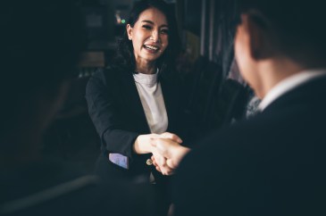 Woman shaking hands with man, hiring