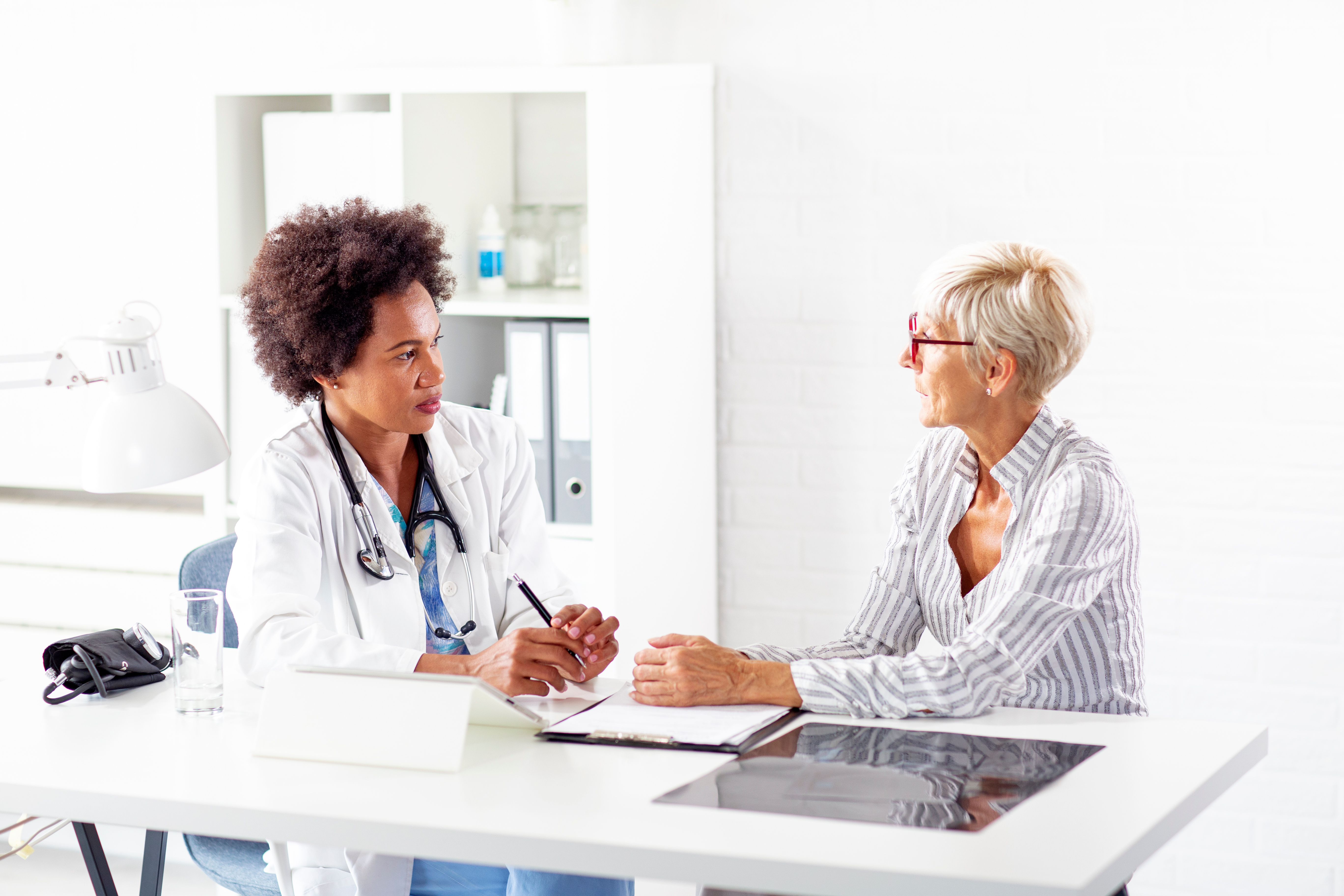 Female doctor speaking with female patient