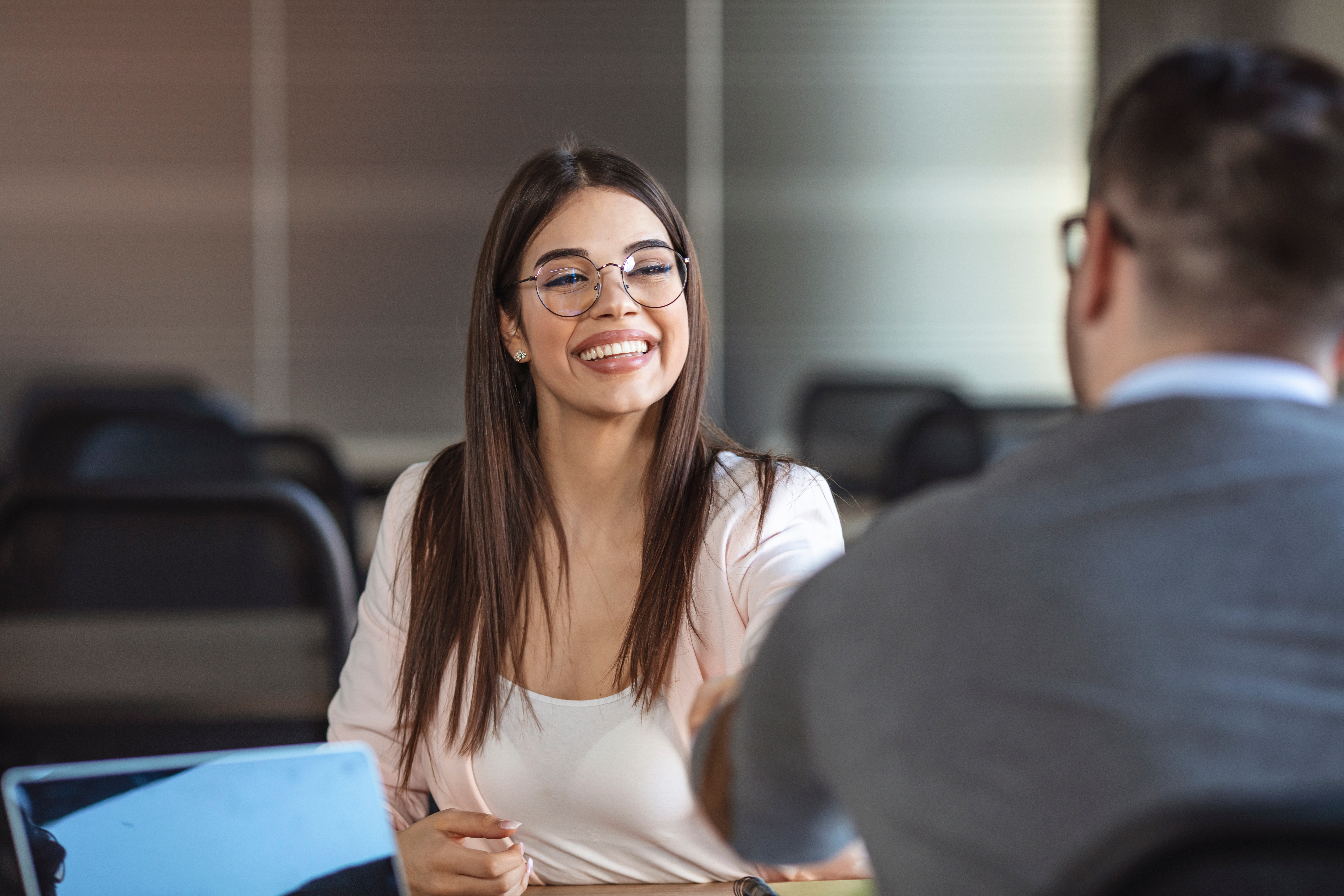Woman in job interview, shaking the hand of man