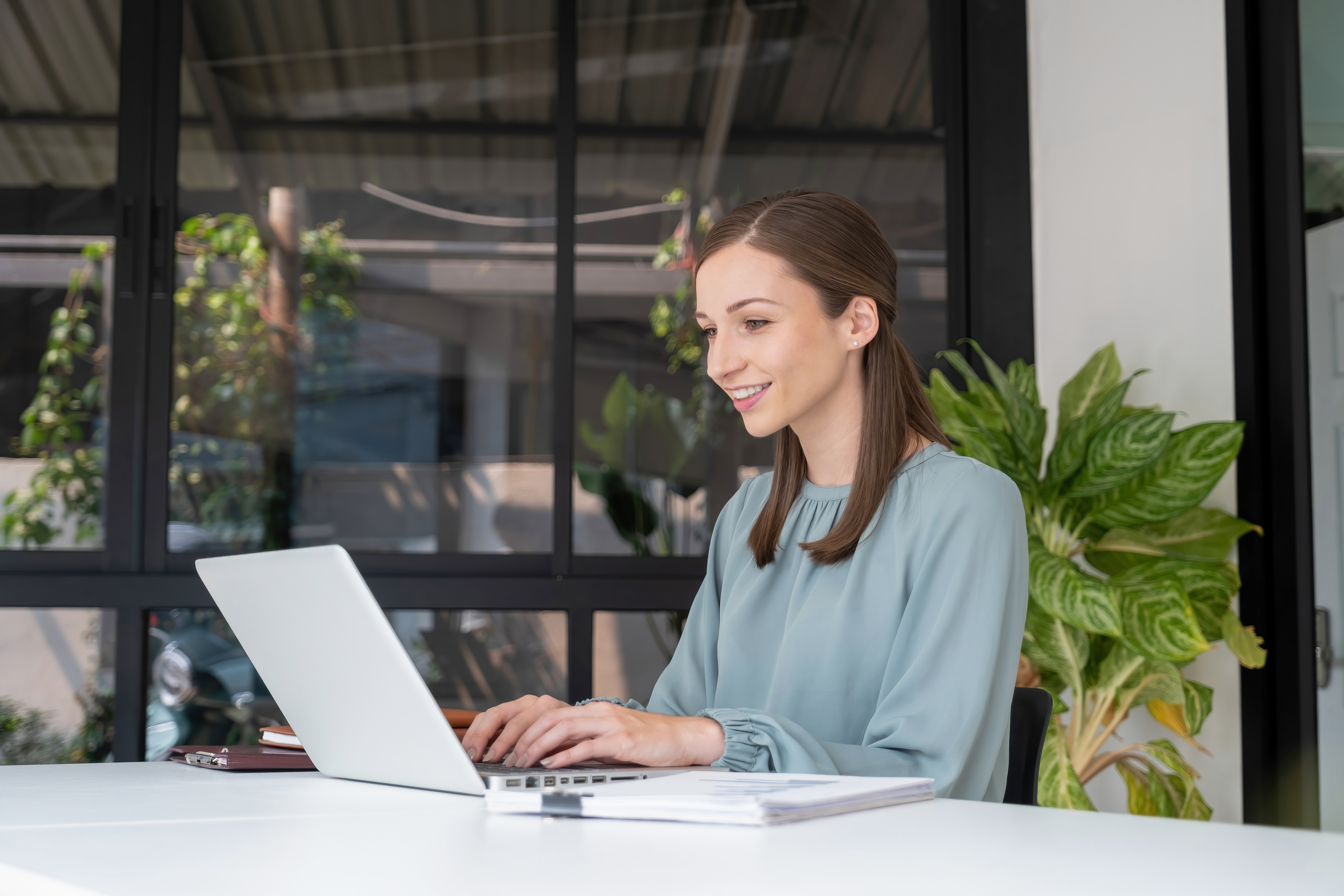 Woman sitting at table working on laptop