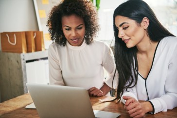 Two women looking at laptop together