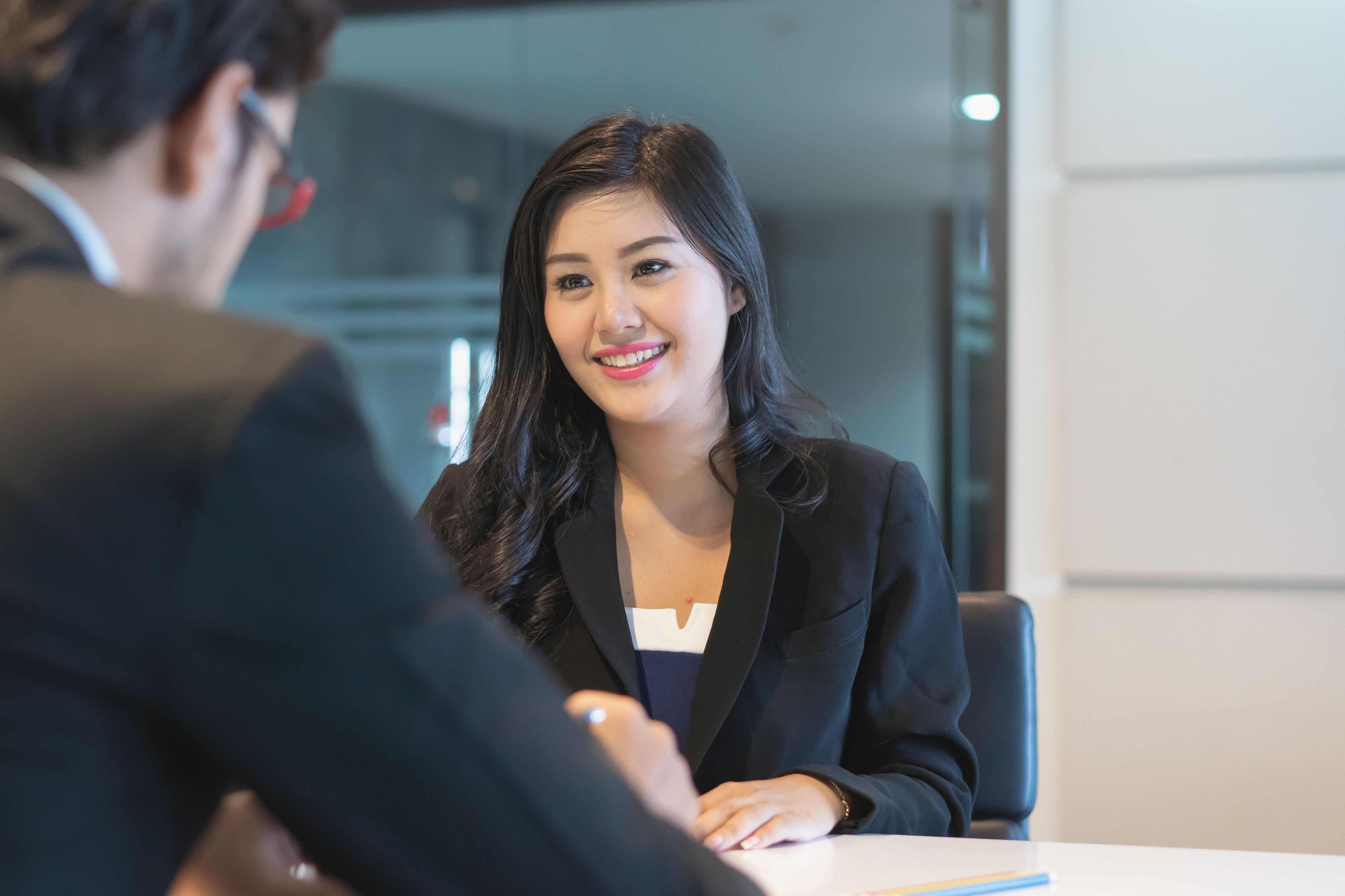 Woman sitting across from man during job interview