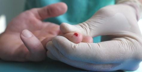 Person getting finger prick at doctor