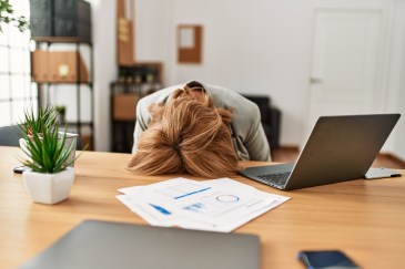 Woman with her head on the desk