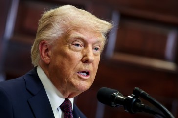 Trump speaking into a microphone
