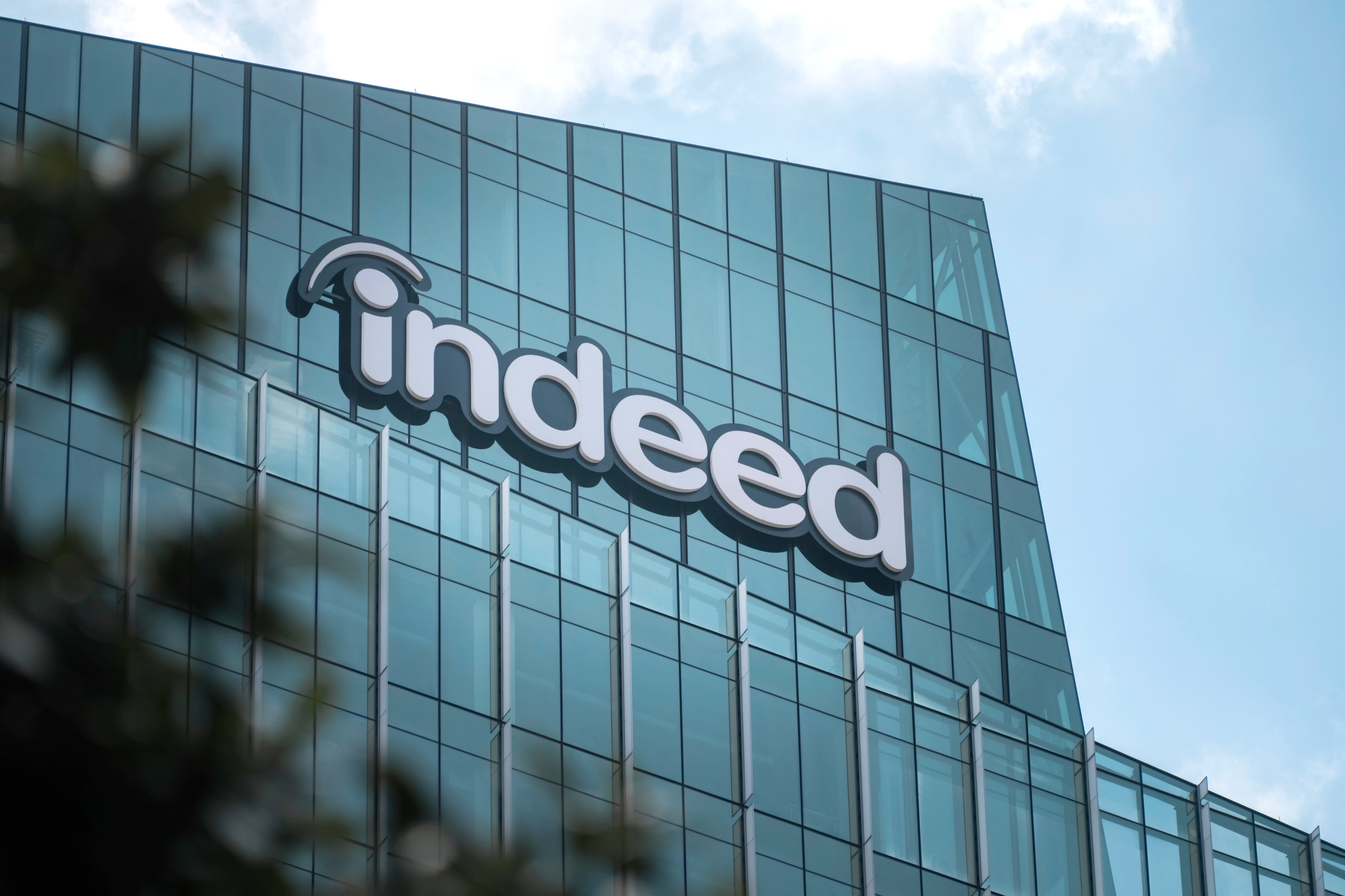 Indeed headquarters: A glass building with indeed spelled out in the bubble letters.