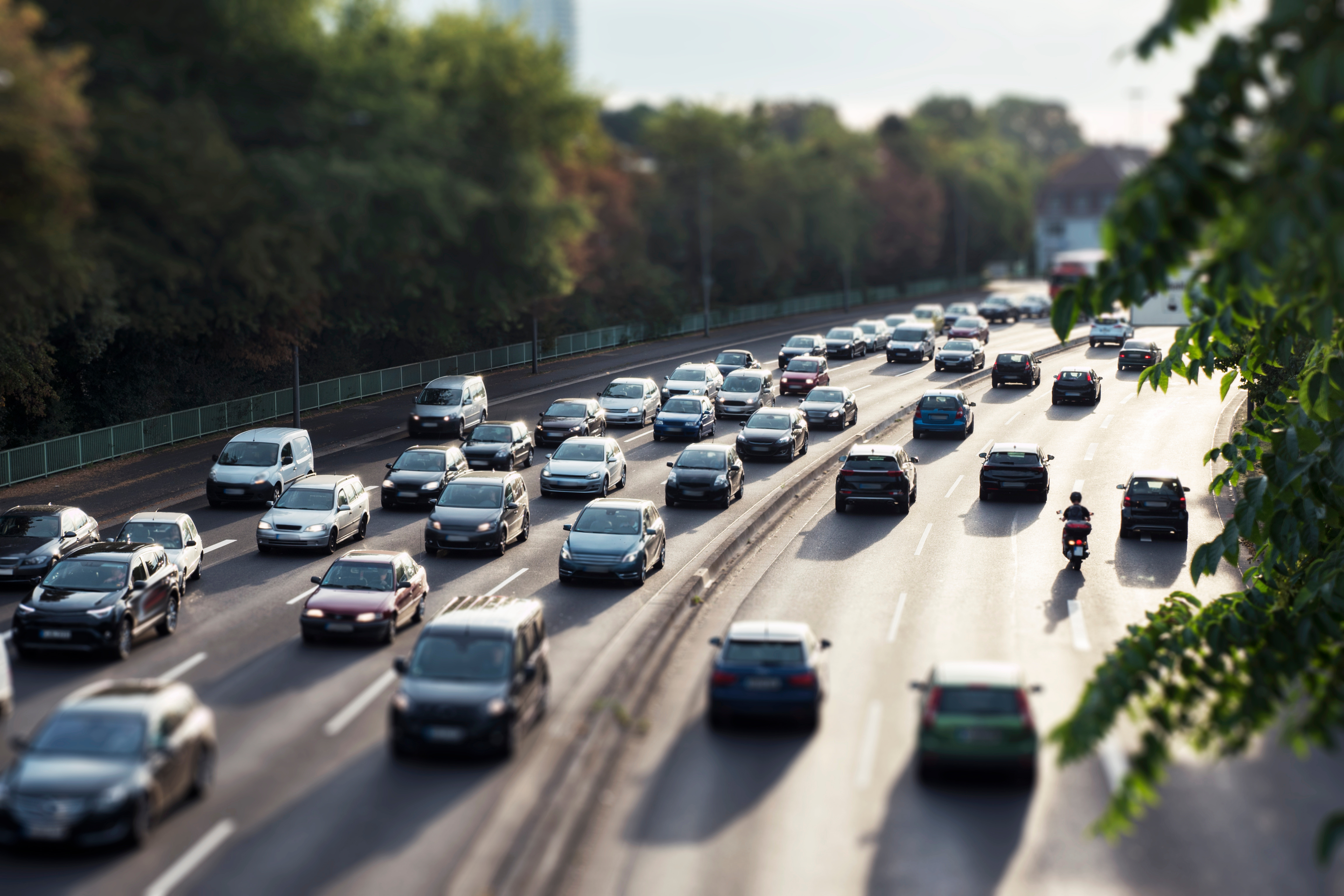 Cars zooming up and down on a freeway.