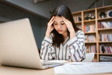 Woman looking stressed at her desk