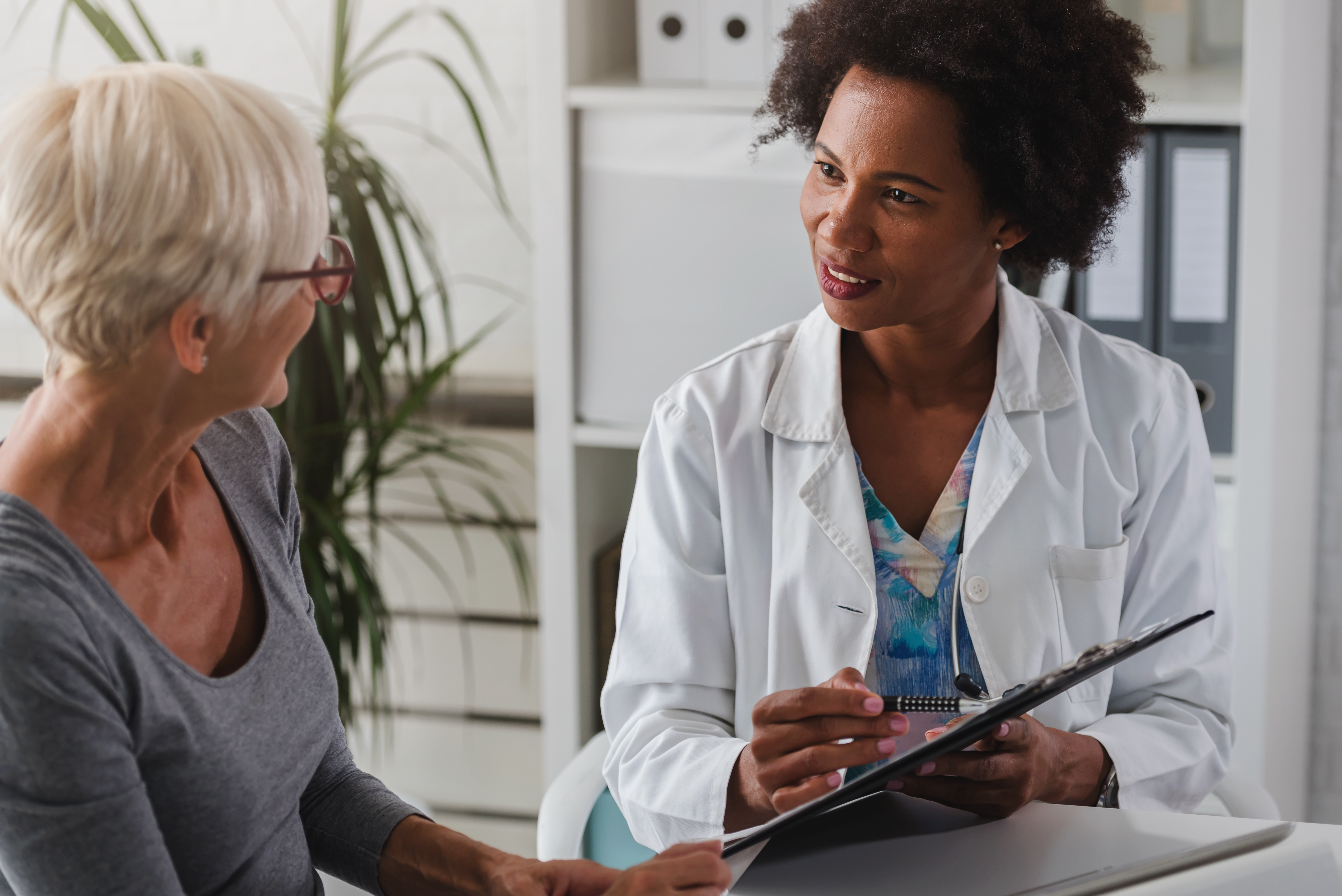 Female doctor with older female patient