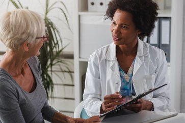 Female doctor with older female patient