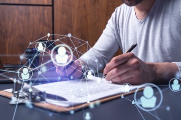 A man is making notes on a document.