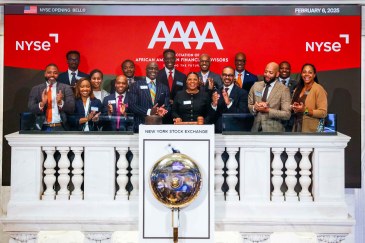 CEO Sheena Gray (front row, center with gavel), Chair Alex David (front row, fourth from left) and other members of the Association of African American Financial Advisors rang the opening bell last month at the New York Stock Exchange.