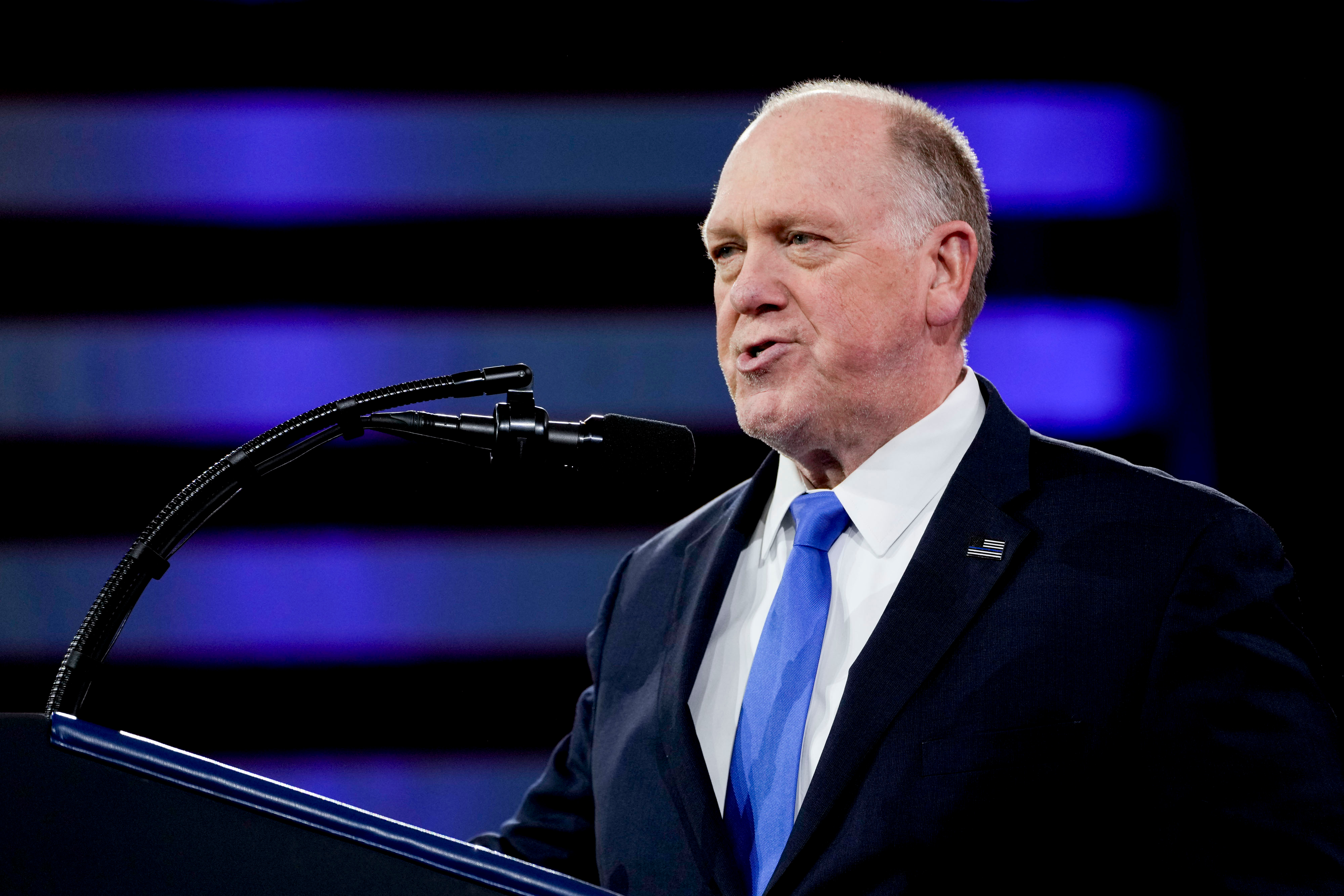 Border Czar Tom Homan speaking at a podium.