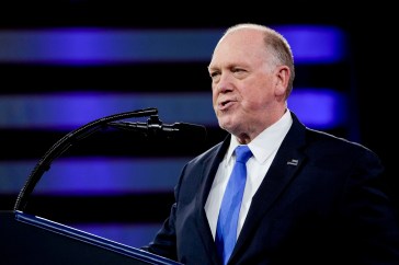 Border Czar Tom Homan speaking at a podium.