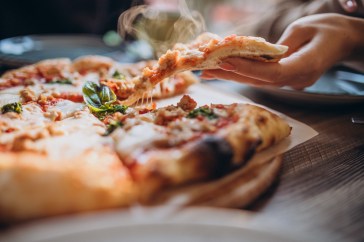 Someone eating pizza