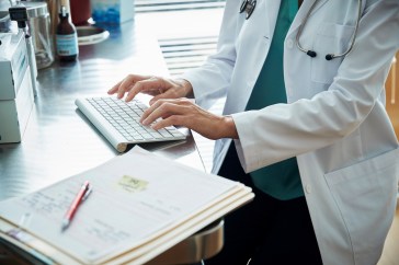 Healthcare worker sitting at a computer