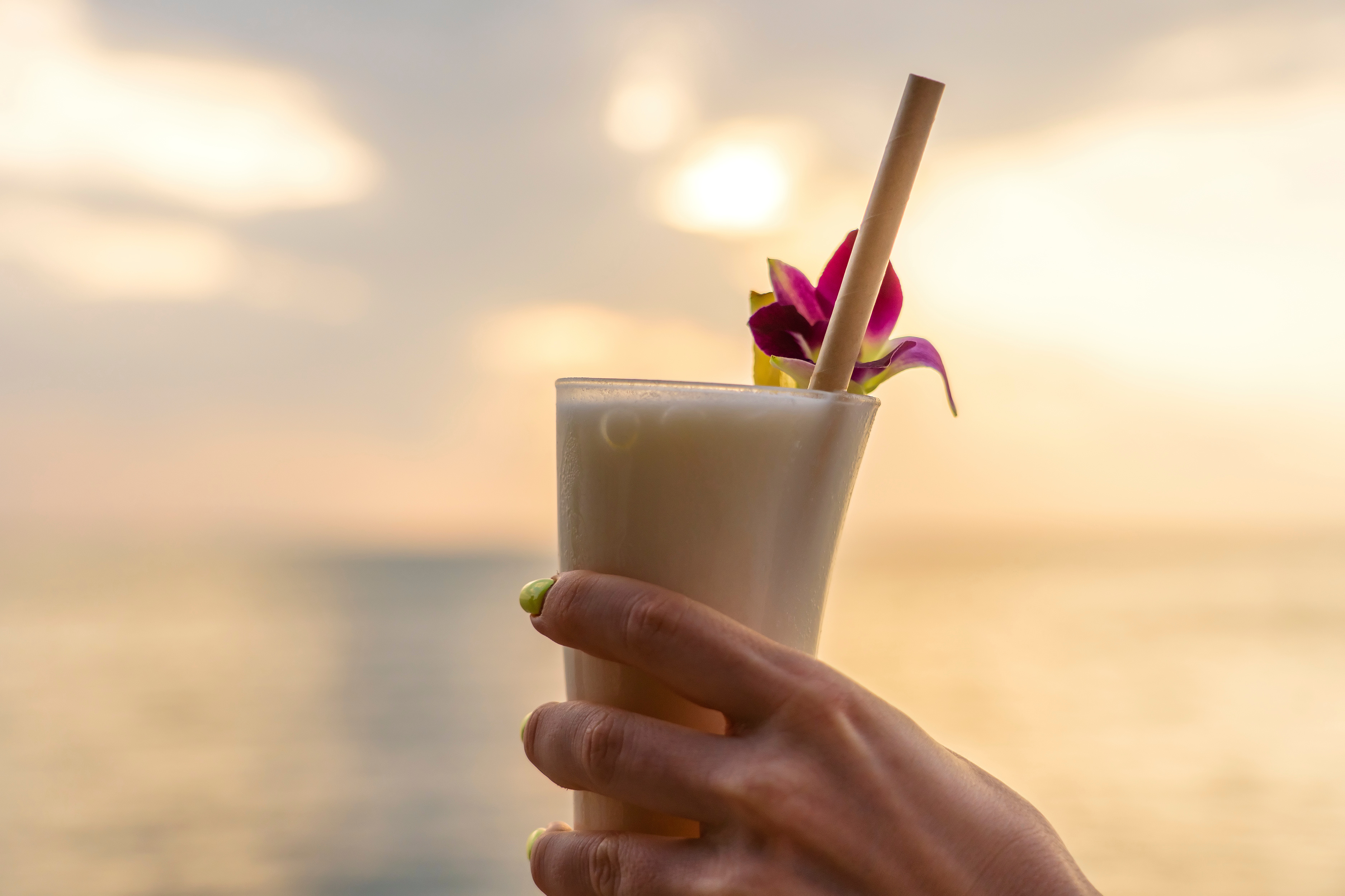 Woman holding a Pina colada drink