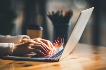 Woman typing into a laptop
