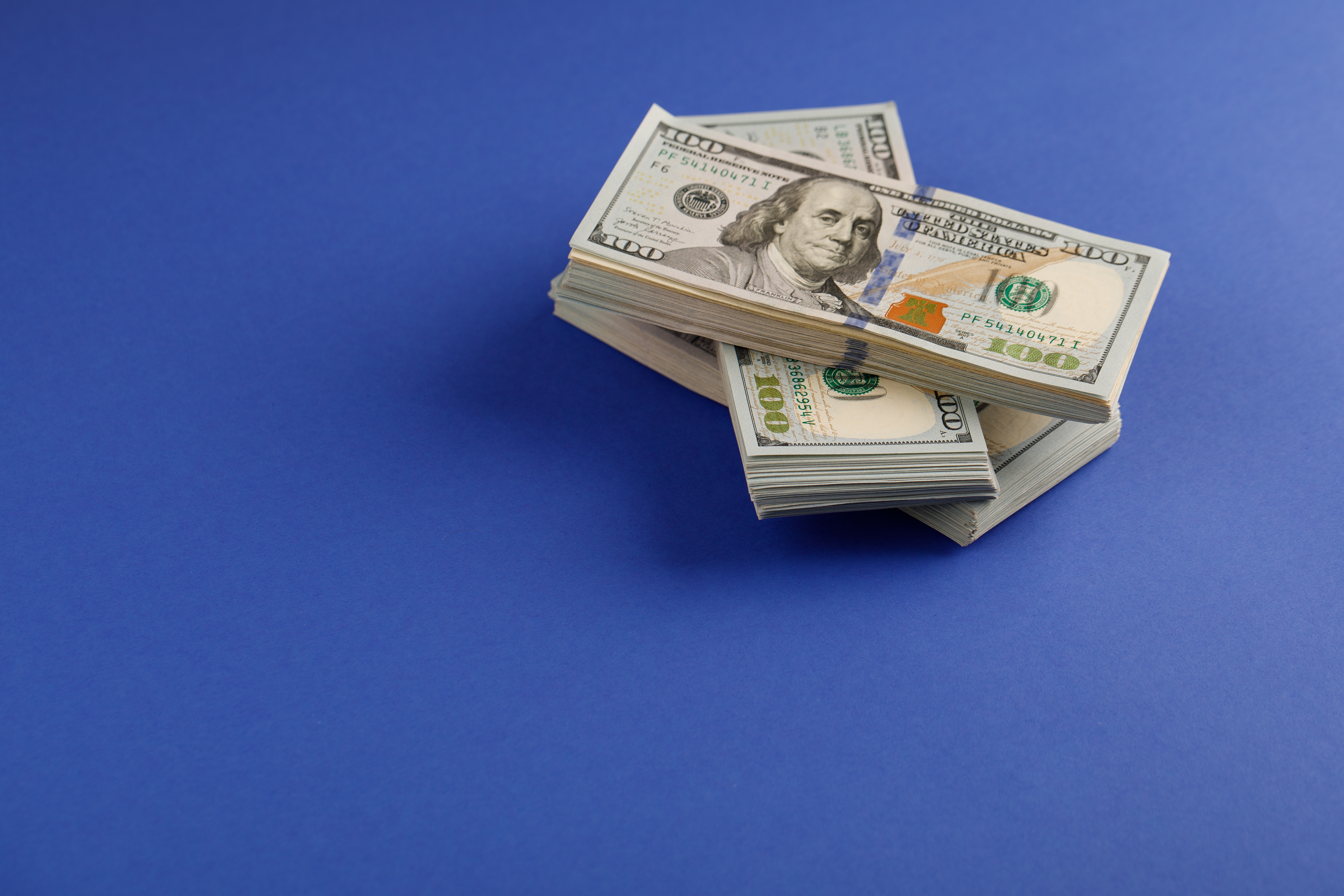 Stacks of money on a blue background