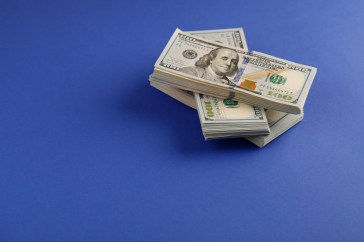 Stacks of money on a blue background