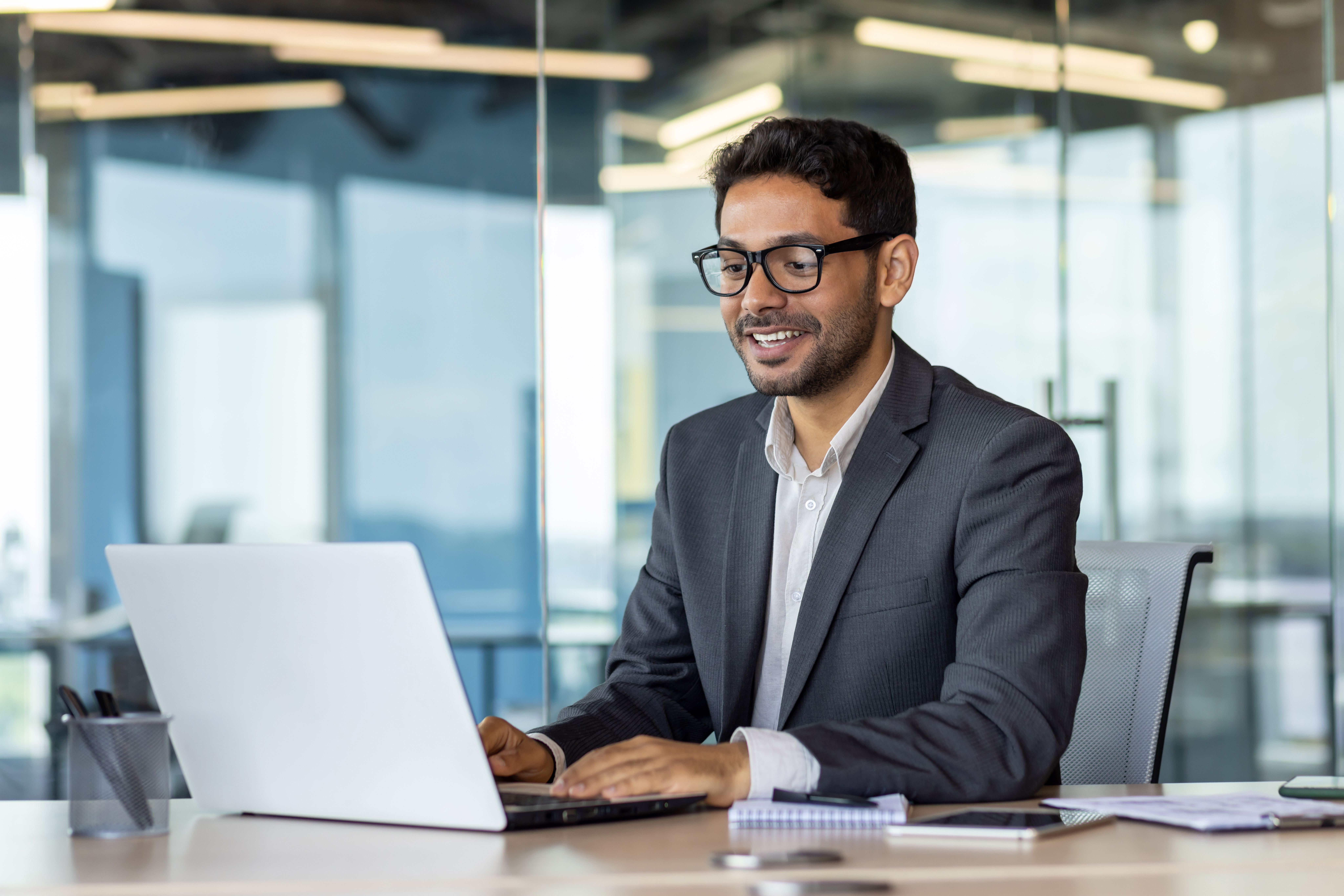 Employee sitting at table using computer