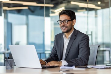 Employee sitting at table using computer