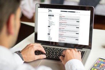 Man looking for jobs on laptop; online