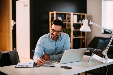 Man working at desk with laptop