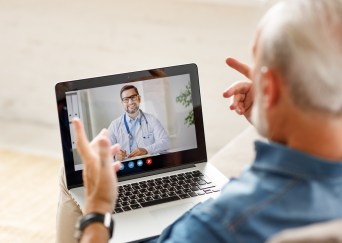 Man speaking with doctor online