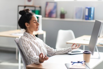 Employee emotional wellness, meditating at desk