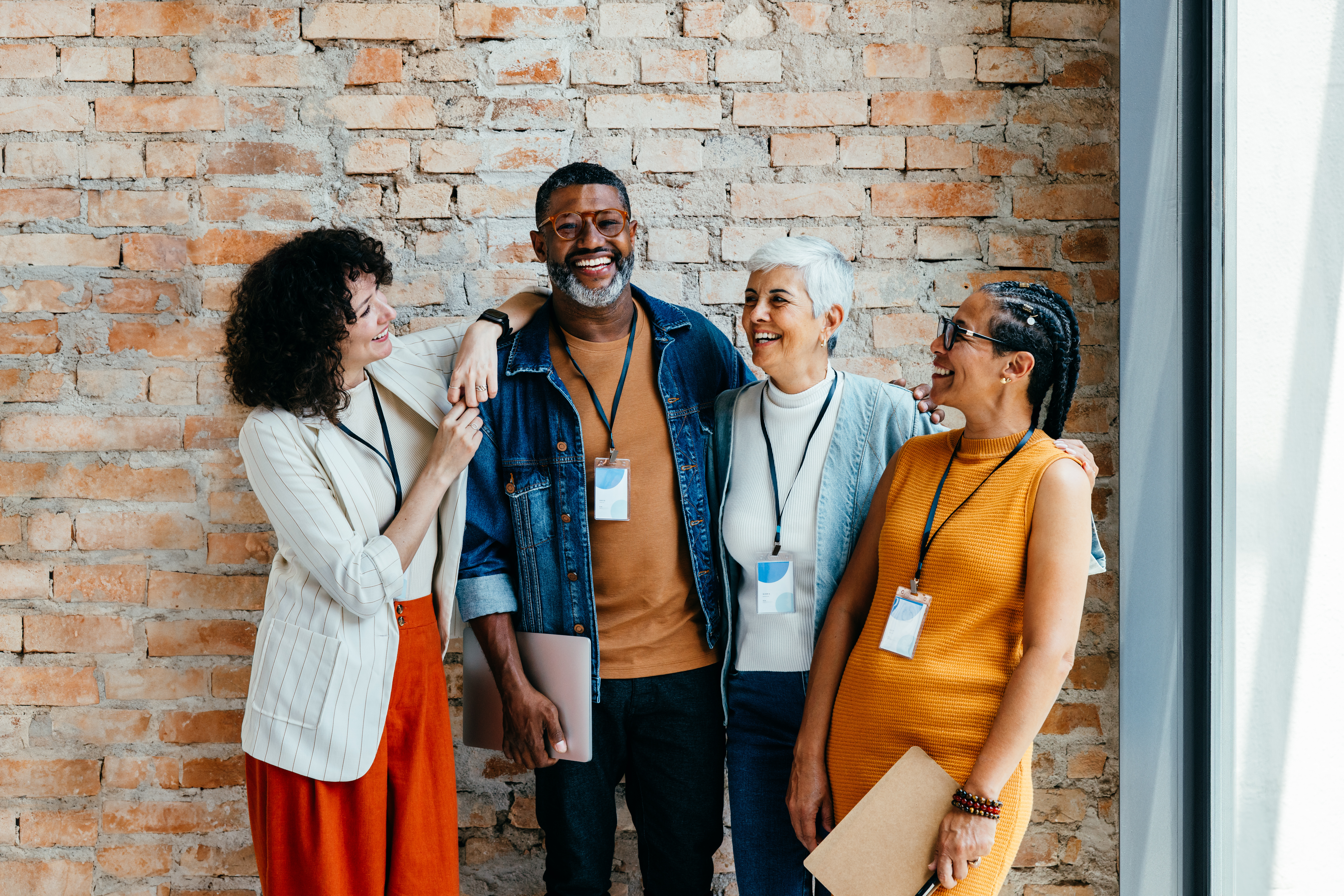 Group of employees, different ages, smiling