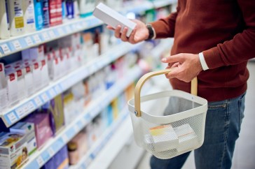 Man putting product in basket, shopping