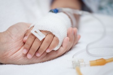 Holding someone's hand in the hospital
