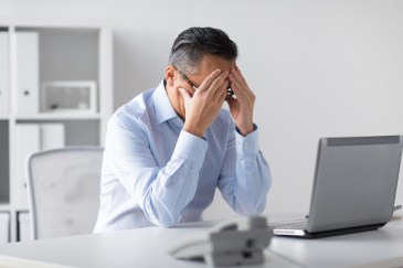 Stressed office worker at desk