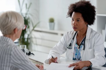Doctor talking to a woman in her office