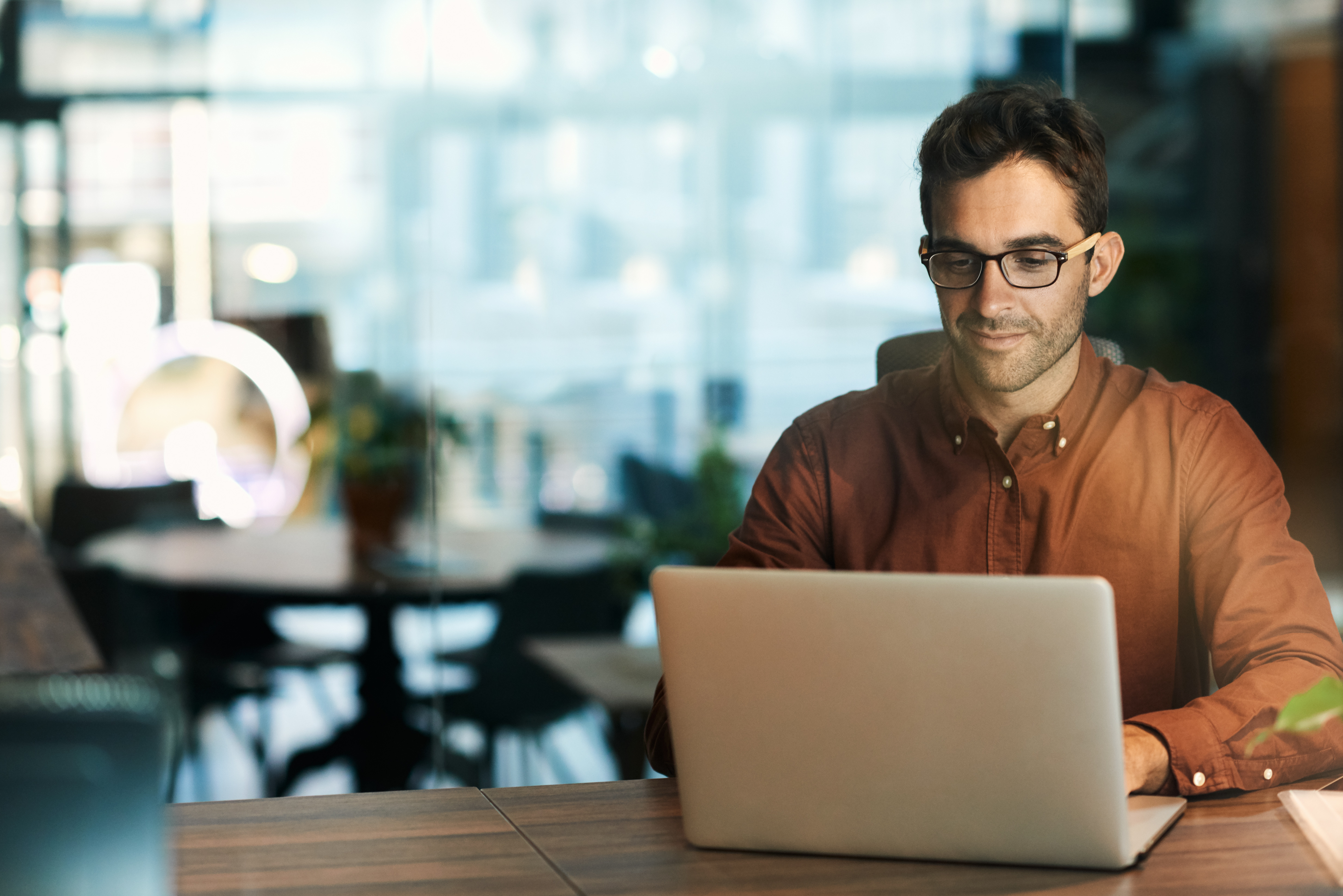 Man with glasses on laptop computer