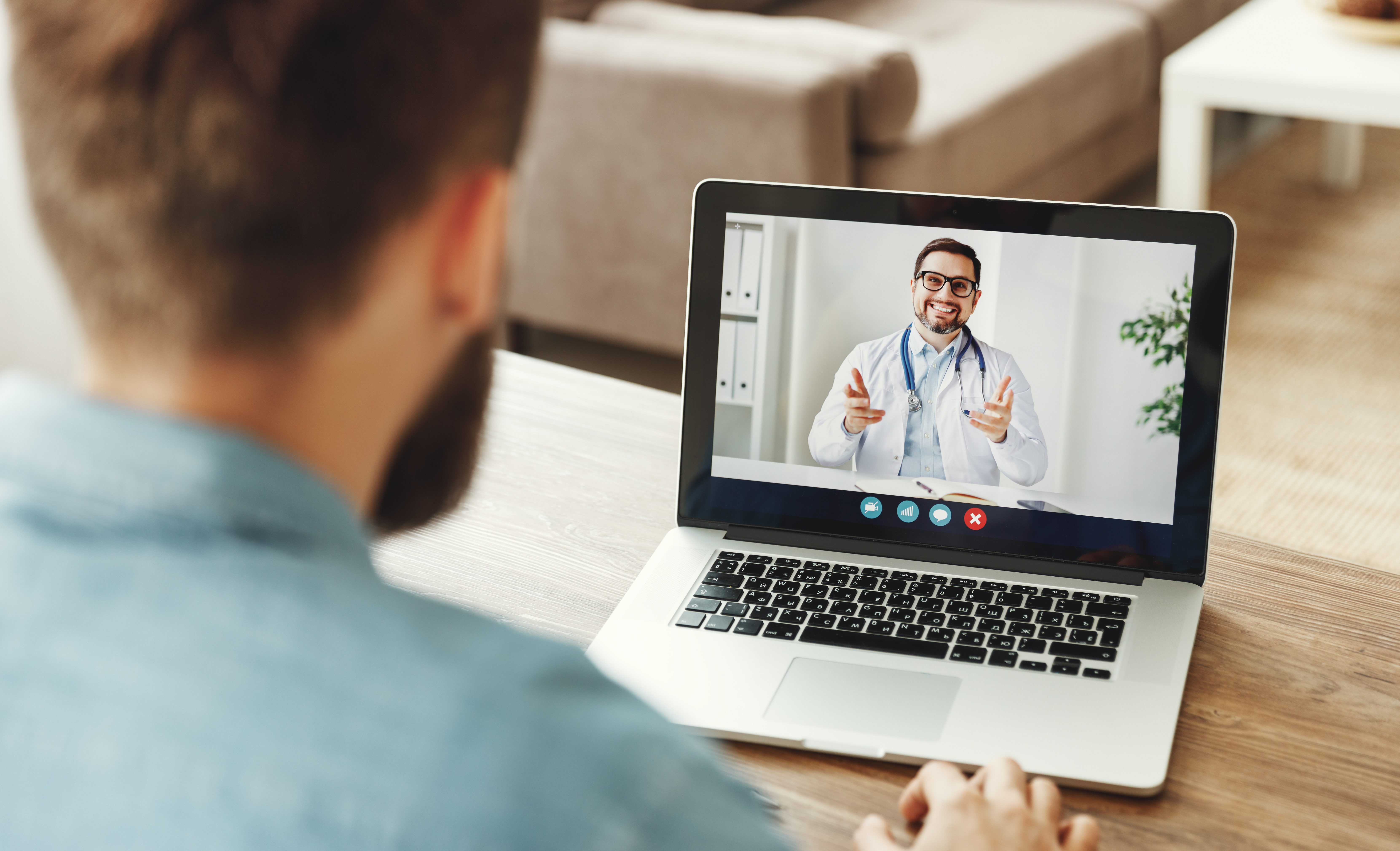 Man speaking with doctor on computer, telehealth
