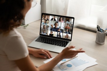Woman working from home in an online meeting on computer
