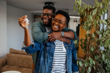Two people celebrating moving into a new home