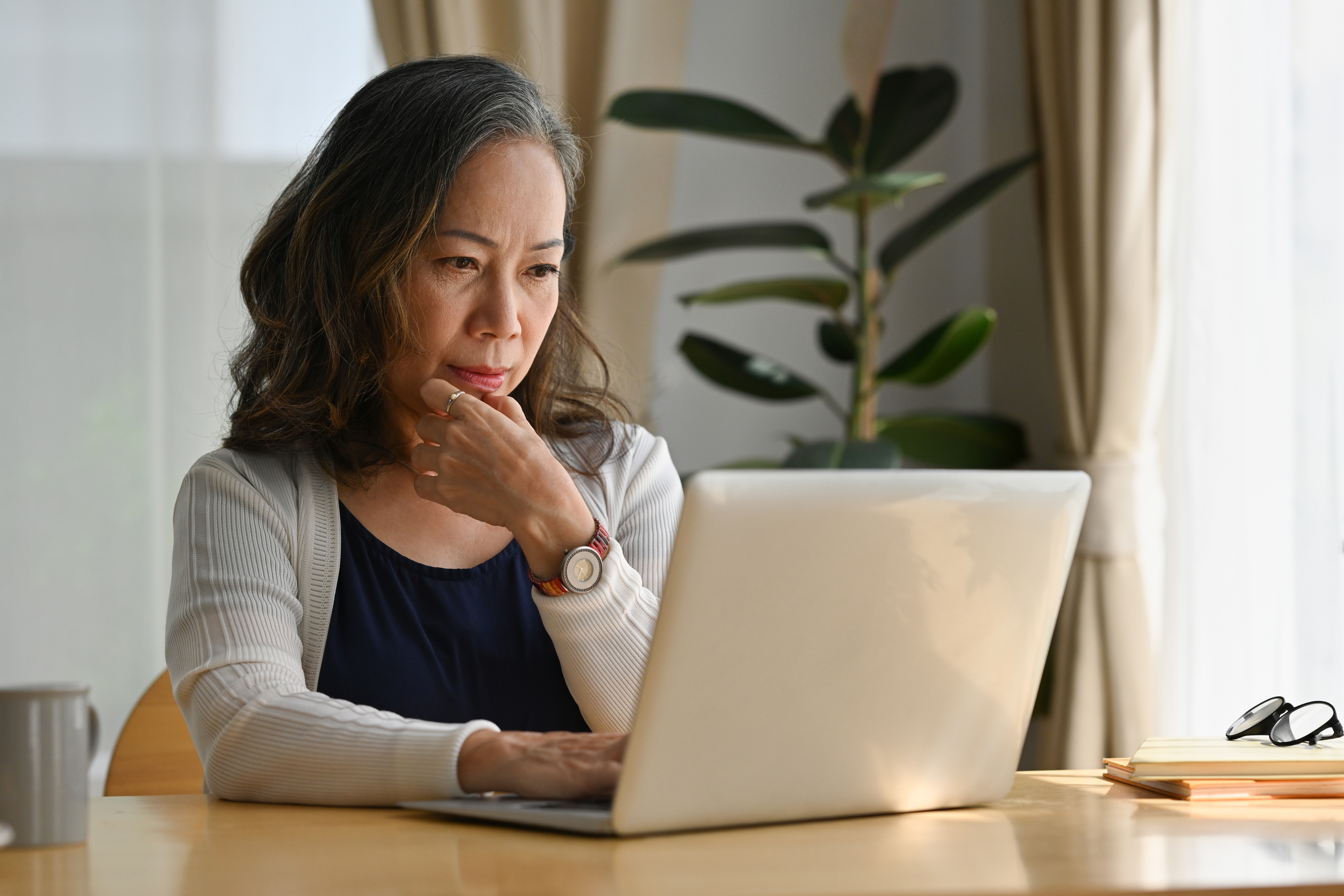 Older woman sitting at a computer working