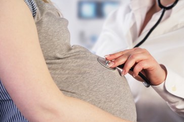 Doctor examining pregnant woman