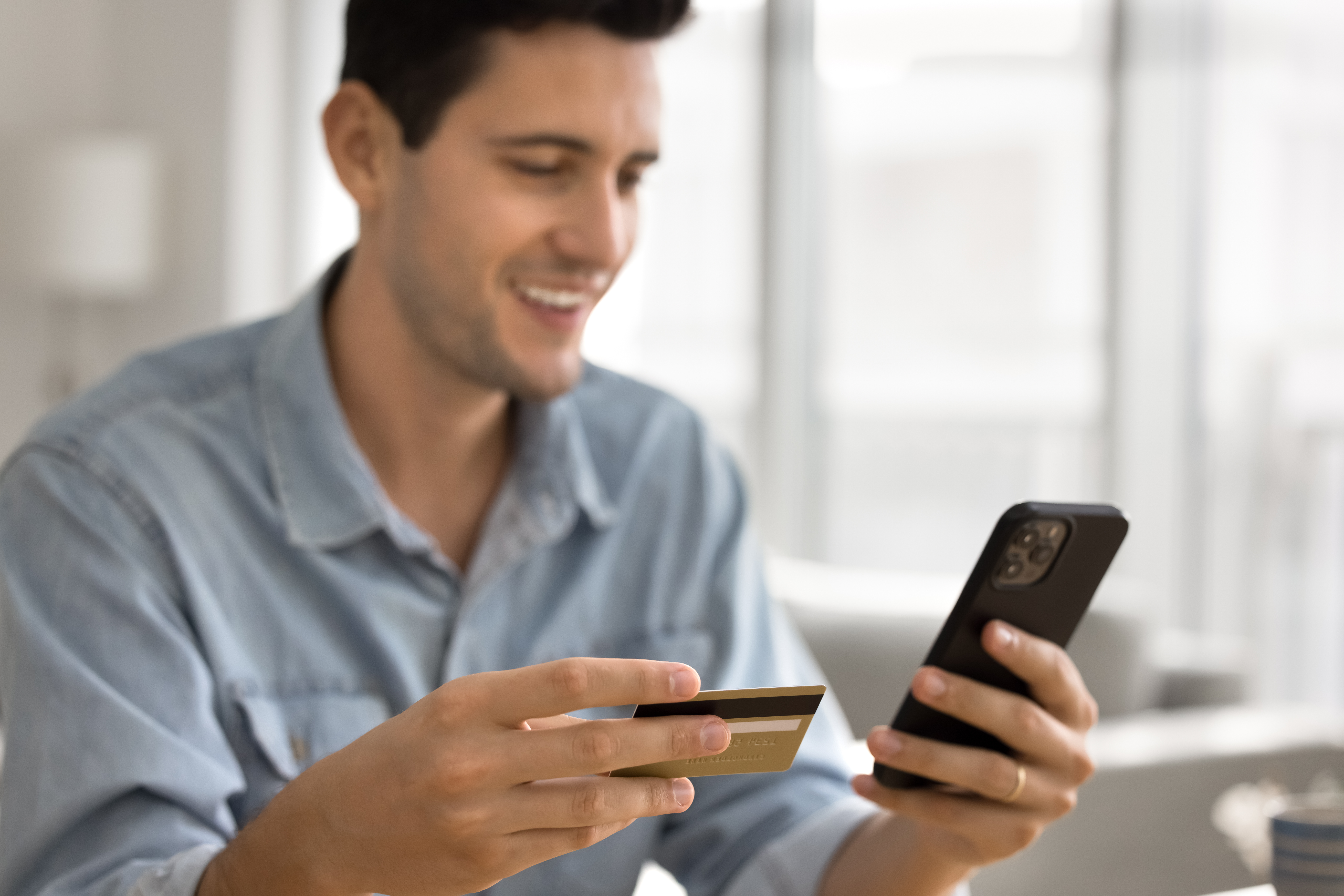 Man using credit card to pay by phone