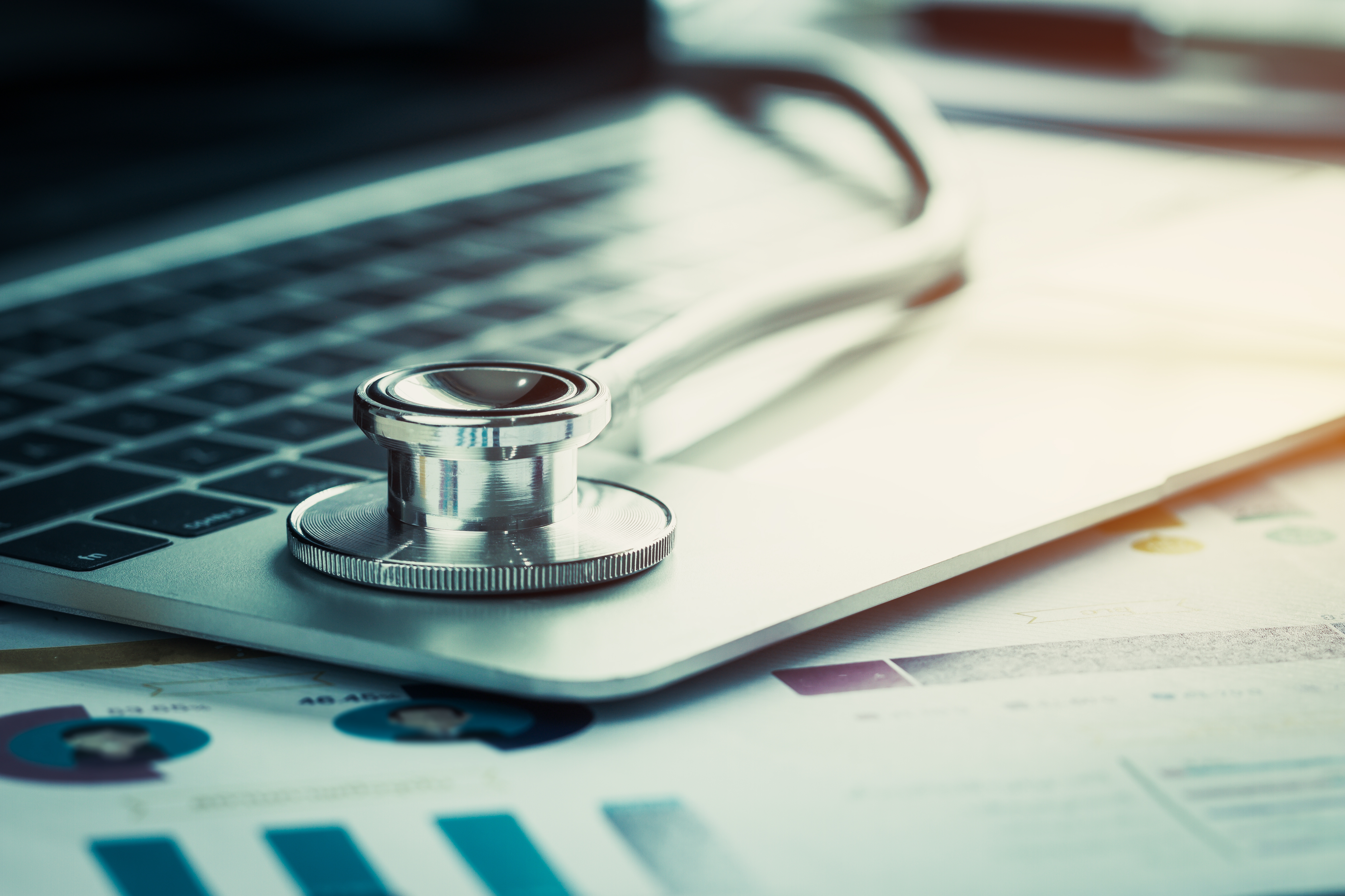 Stethoscope on a computer with budget charts