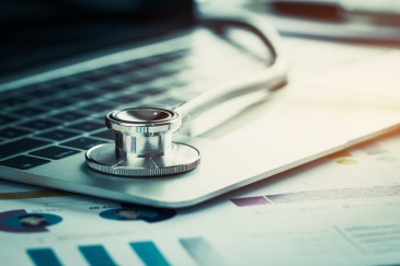 Stethoscope on a computer with budget charts