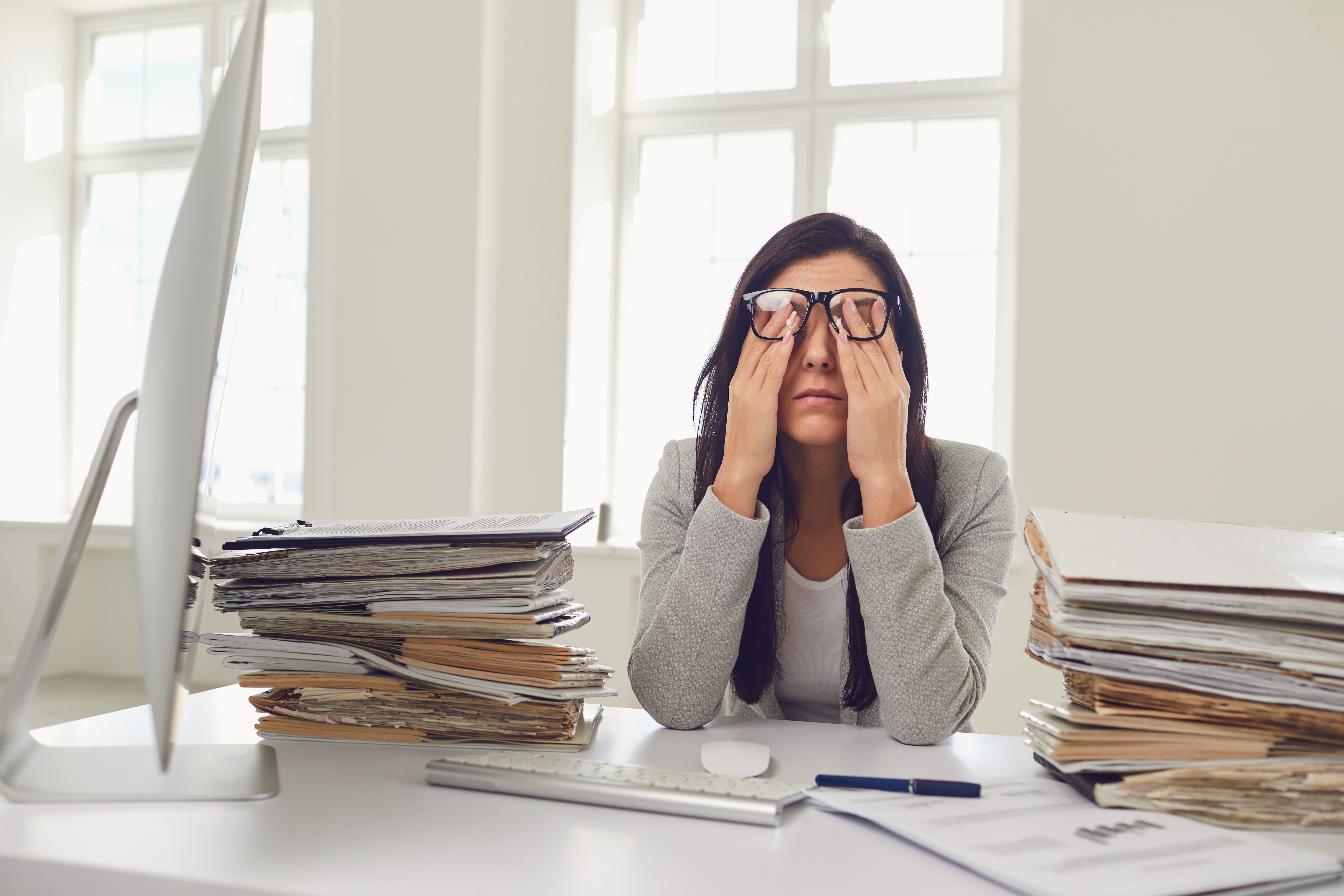 Woman looking stressed and overwhelmed at work