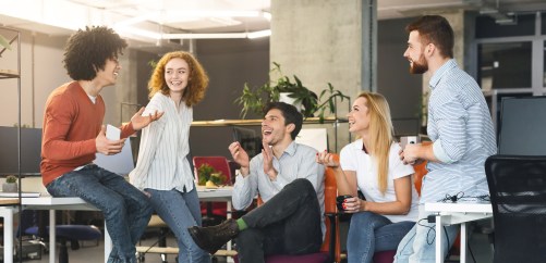 Group of young employees talking, laughing