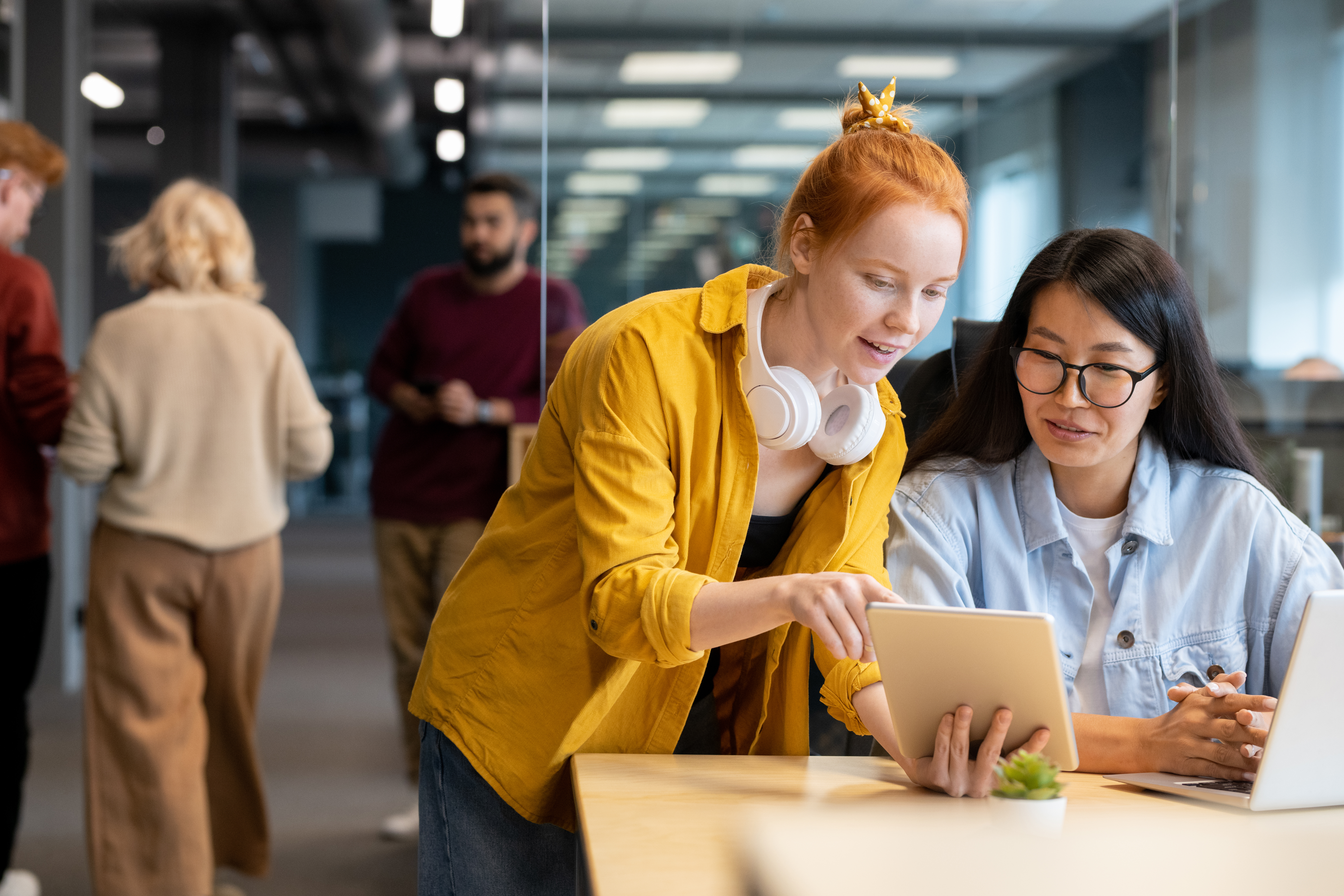 Two employees talking in office