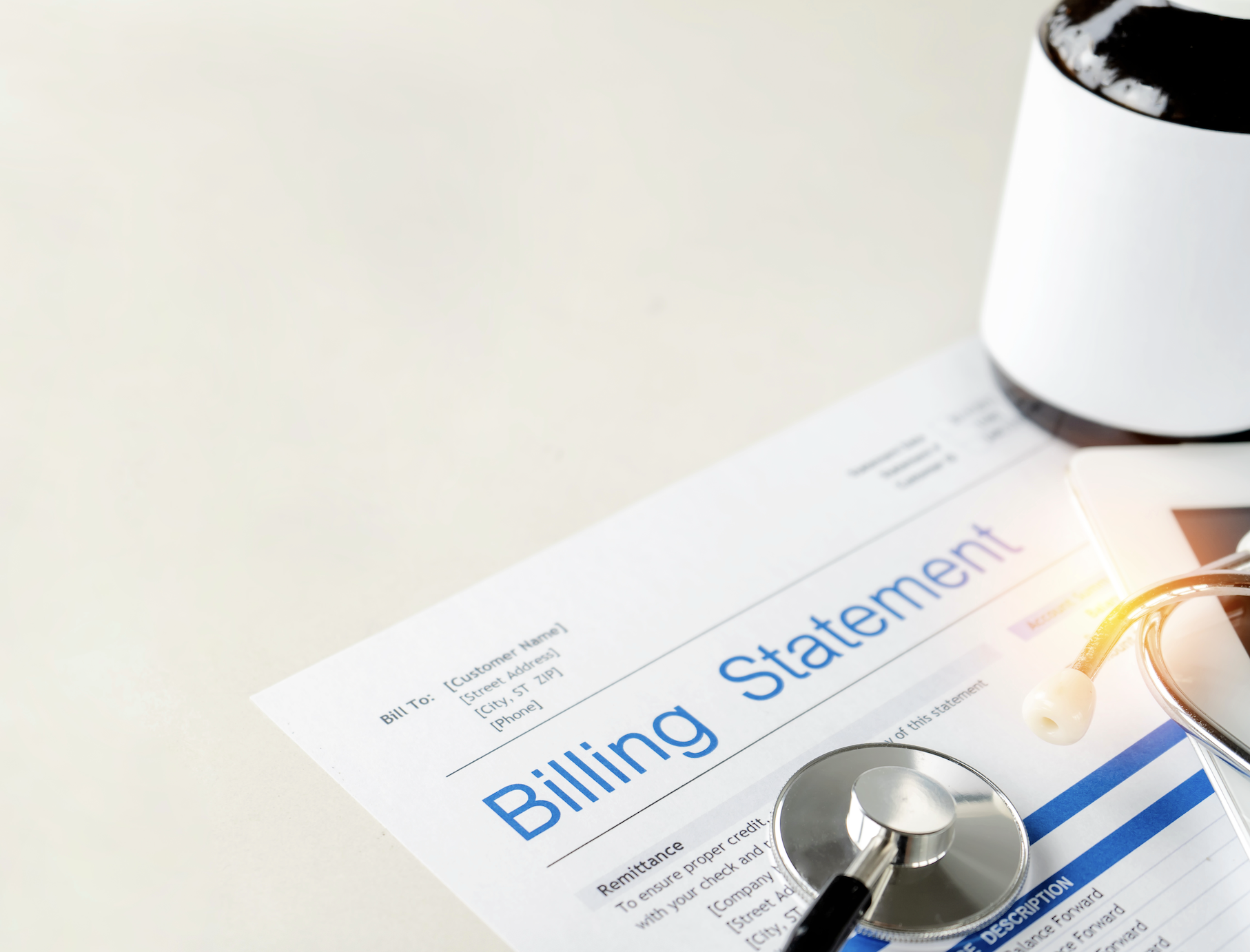 Medical stethoscope on top of a billing statement