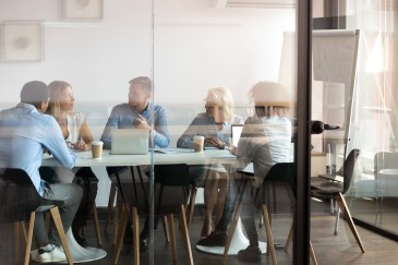 People meeting inside a board room.