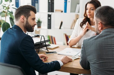 Advisers meeting with a client